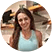 A woman smiling in a kitchen.